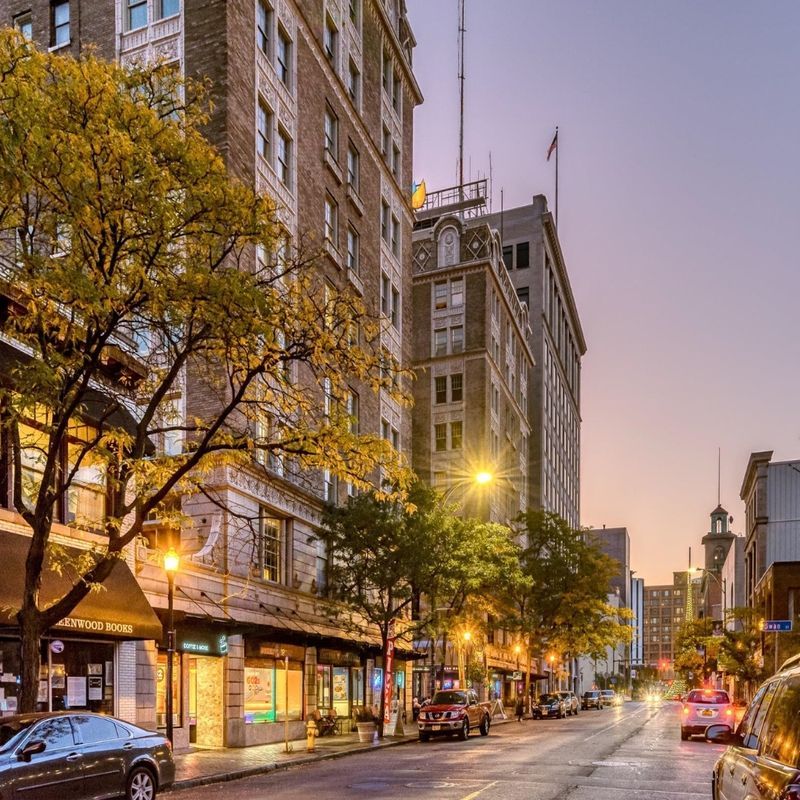 Downtown street at dusk near furnished rental communities